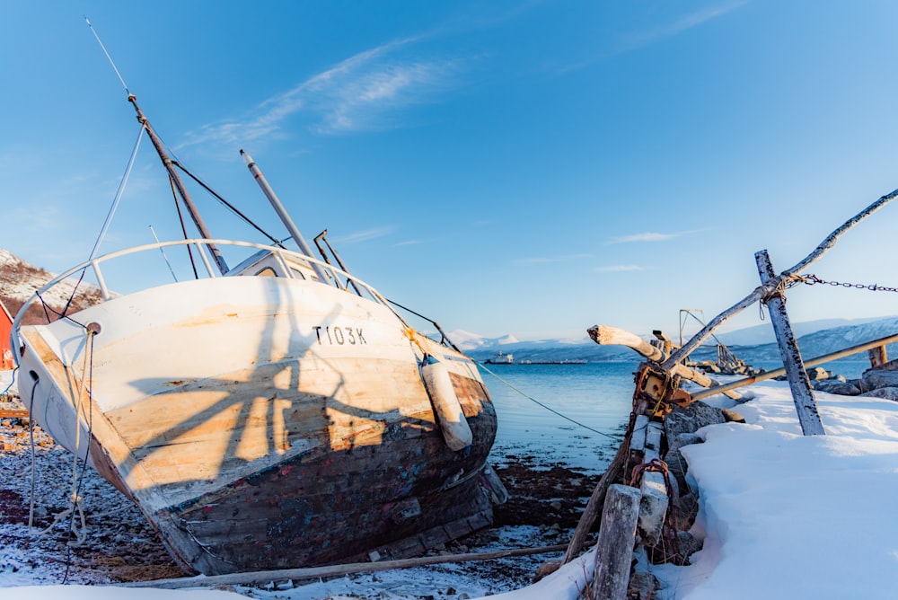 white and brown sailing boat on body of water