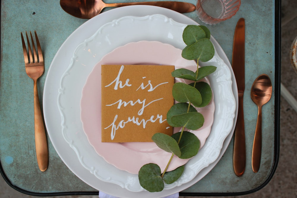 green leaf on table with fork, spoon, and knife