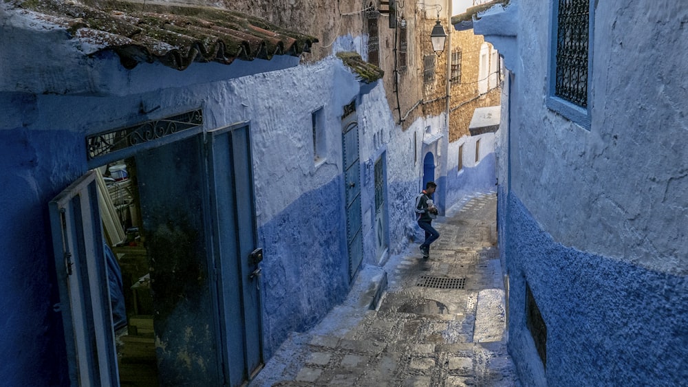 man in pathway in middle of house during daytime