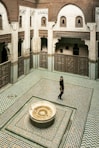 a person standing in a room with a fountain