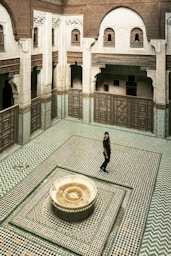 a person standing in a room with a fountain