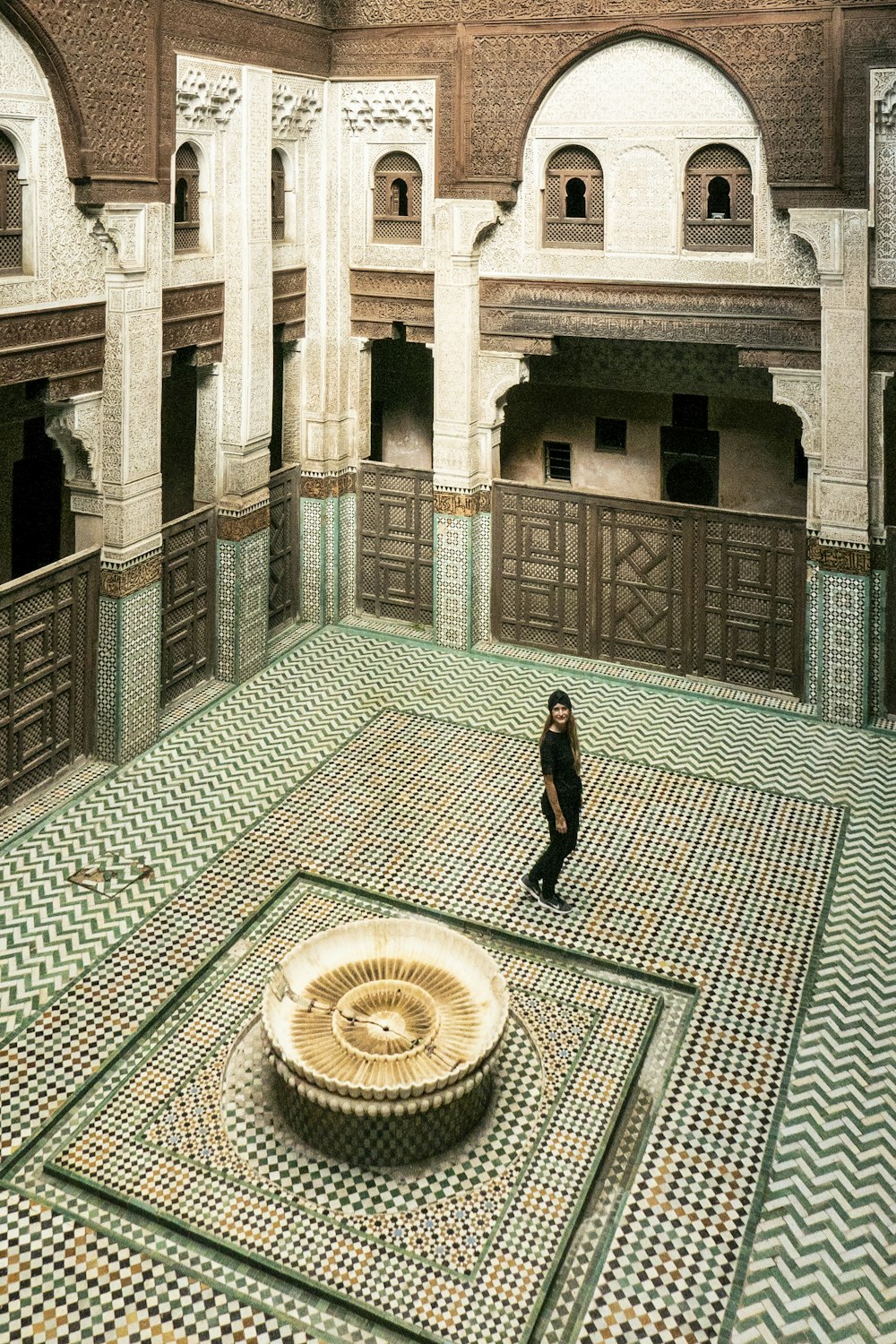 a person standing in a room with a fountain