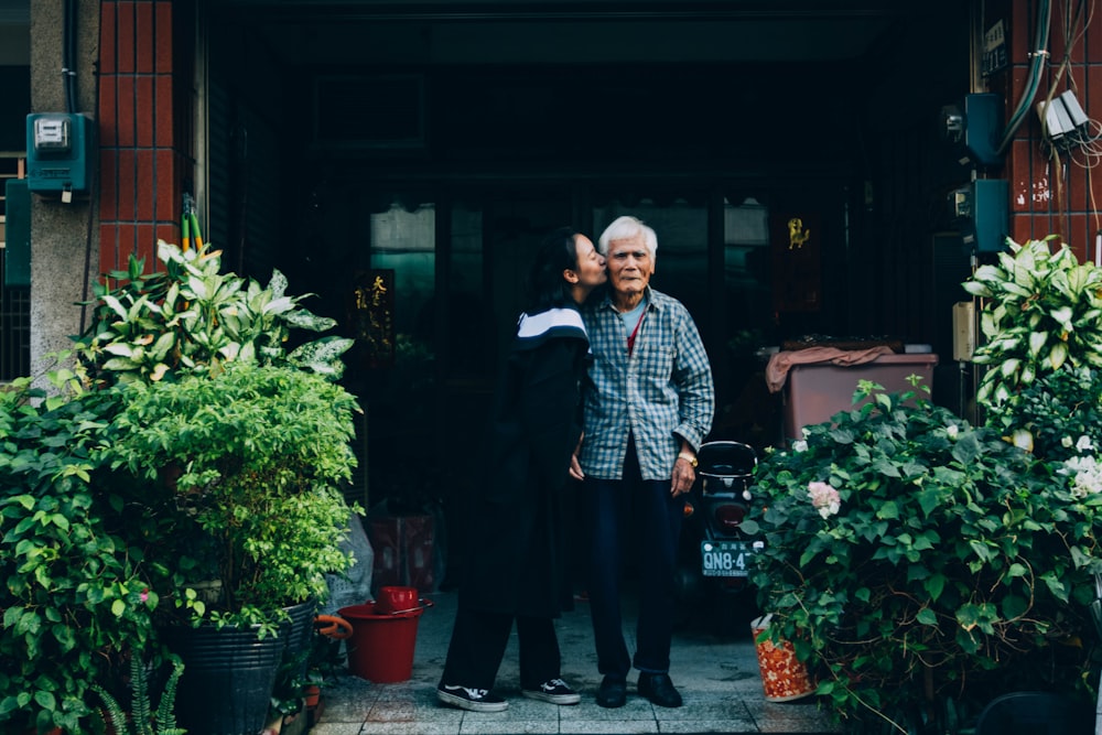 woman kissing man standing