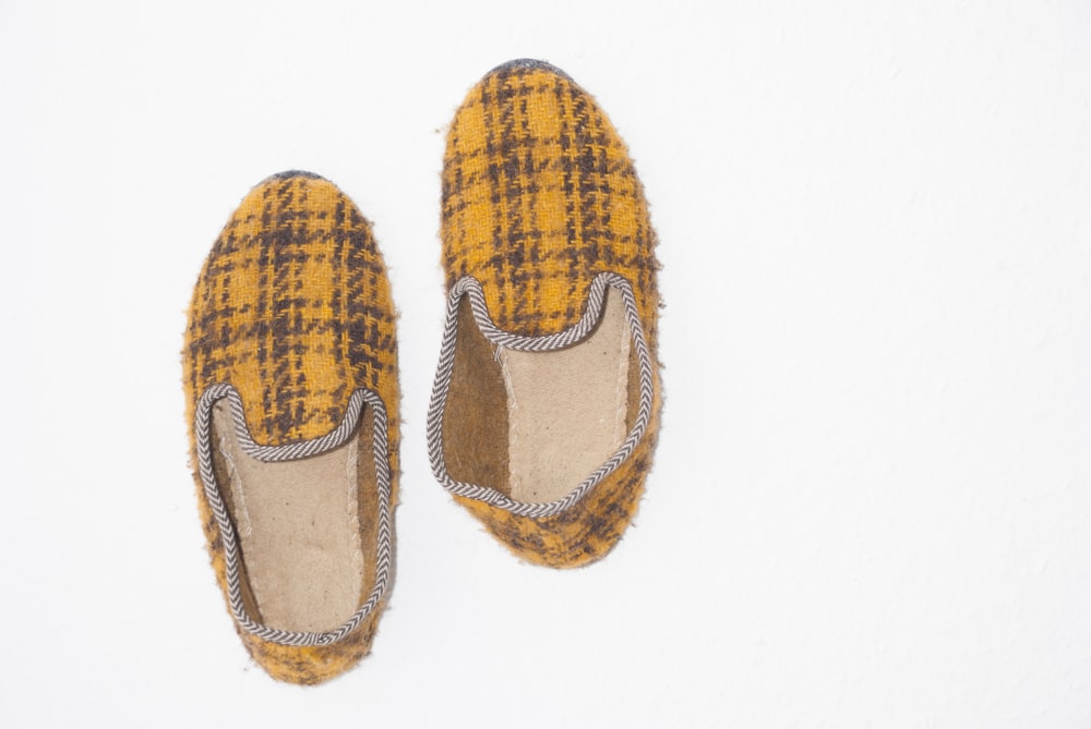 pair of yellow-and-black plaid slip-on shoes