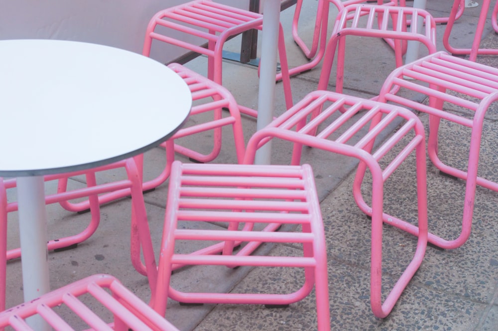 round white pedestal table and pink chairs