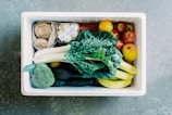 A delivery box filled with assorted fresh vegetables ready for doorstep delivery.