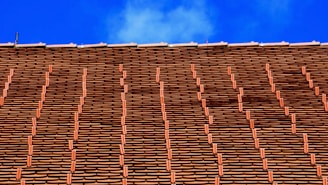 Wide shot of a residential home featuring a newly tiled roof with neat, uniform rows.