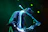 Guitarist performing on stage using a Kraken guitar pick under dramatic lighting.