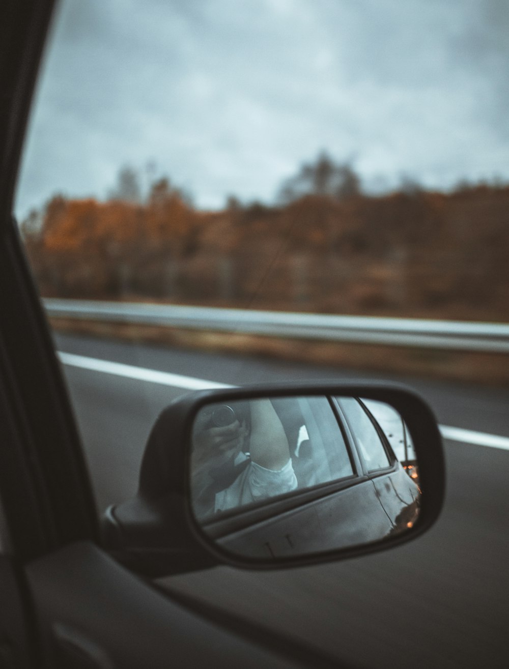 person showing black side mirror