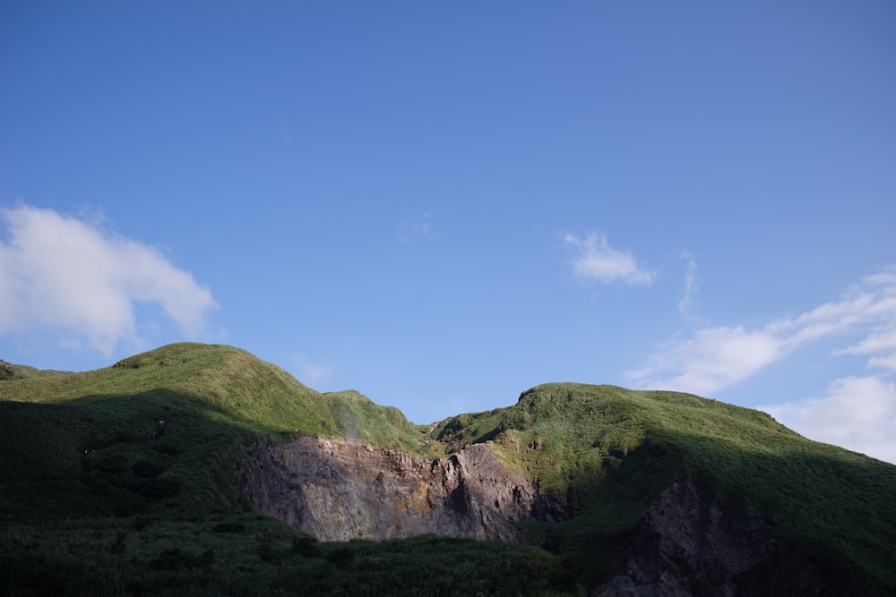 grass covered mountains during day