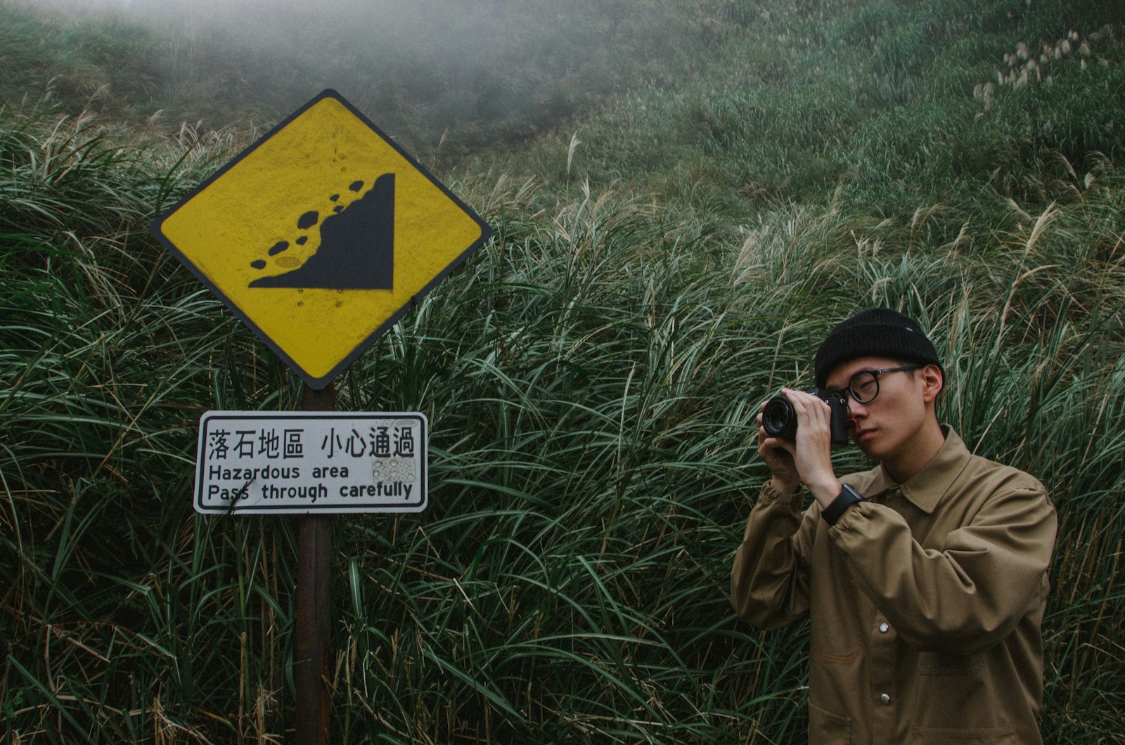 Sigma 17-70mm F2.8-4 DC Macro OS HSM sample photo. Man standing beside road photography