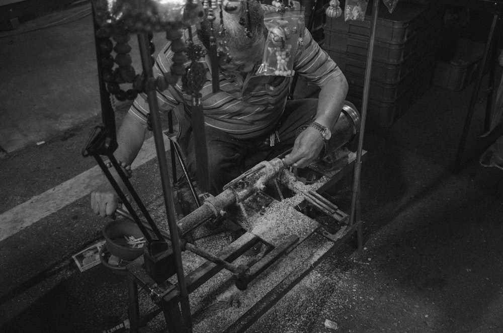 grayscale photography of man holding pipess