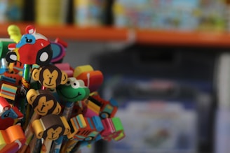 Glue sticks and sharpeners decorated with playful Disney themes on a white surface.