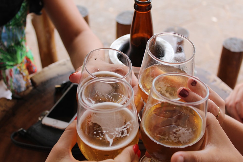 four clear stemless glasses