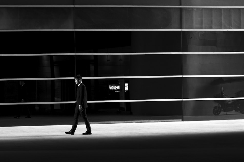 man walking near wall