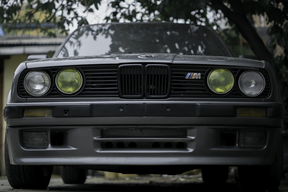 black BMW M series car parked near tree