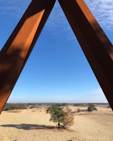 A long-range metal detector scanning a vast desert landscape under a clear blue sky.