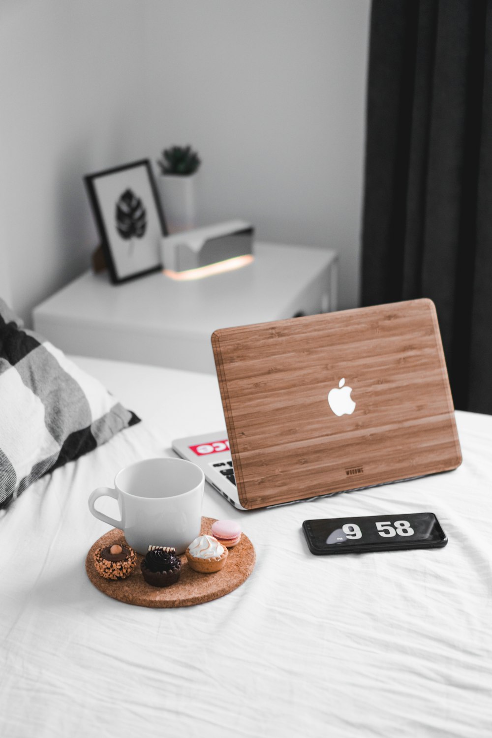 MacBook beside white mug