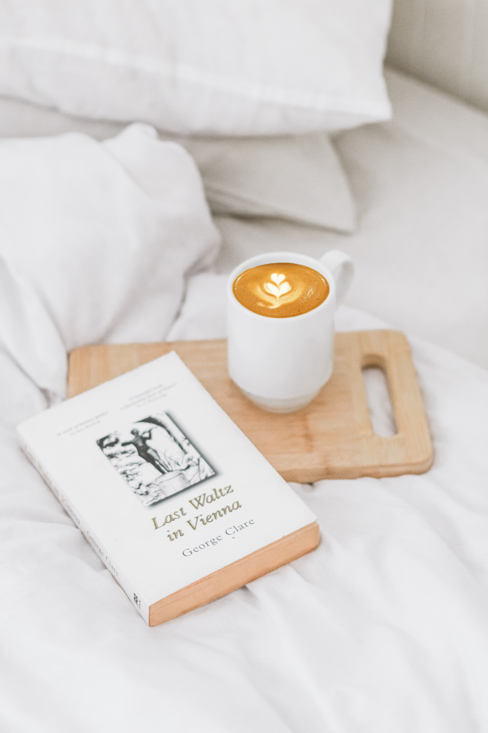 latte art filled mug on wooden chopping board