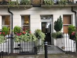 The exterior of a sleek, newly renovated townhouse with a welcoming entrance.