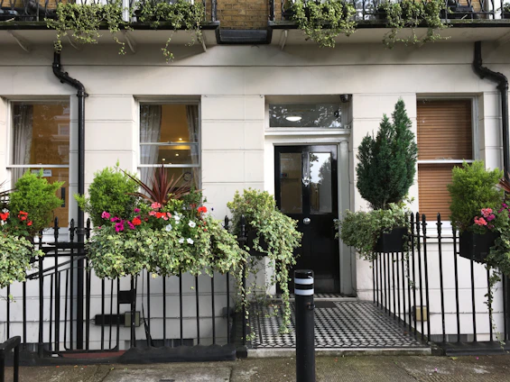 Elegant townhouse exterior with sleek black and gold accents and a private courtyard.