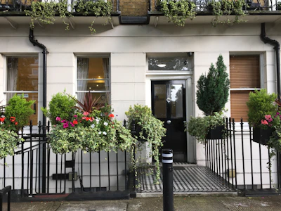 The exterior of a sleek, newly renovated townhouse with a welcoming entrance.