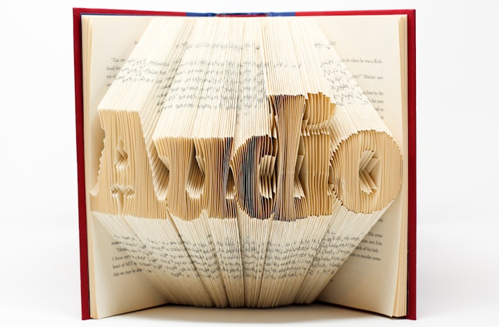 Book art where the pages are cut to spell Audio