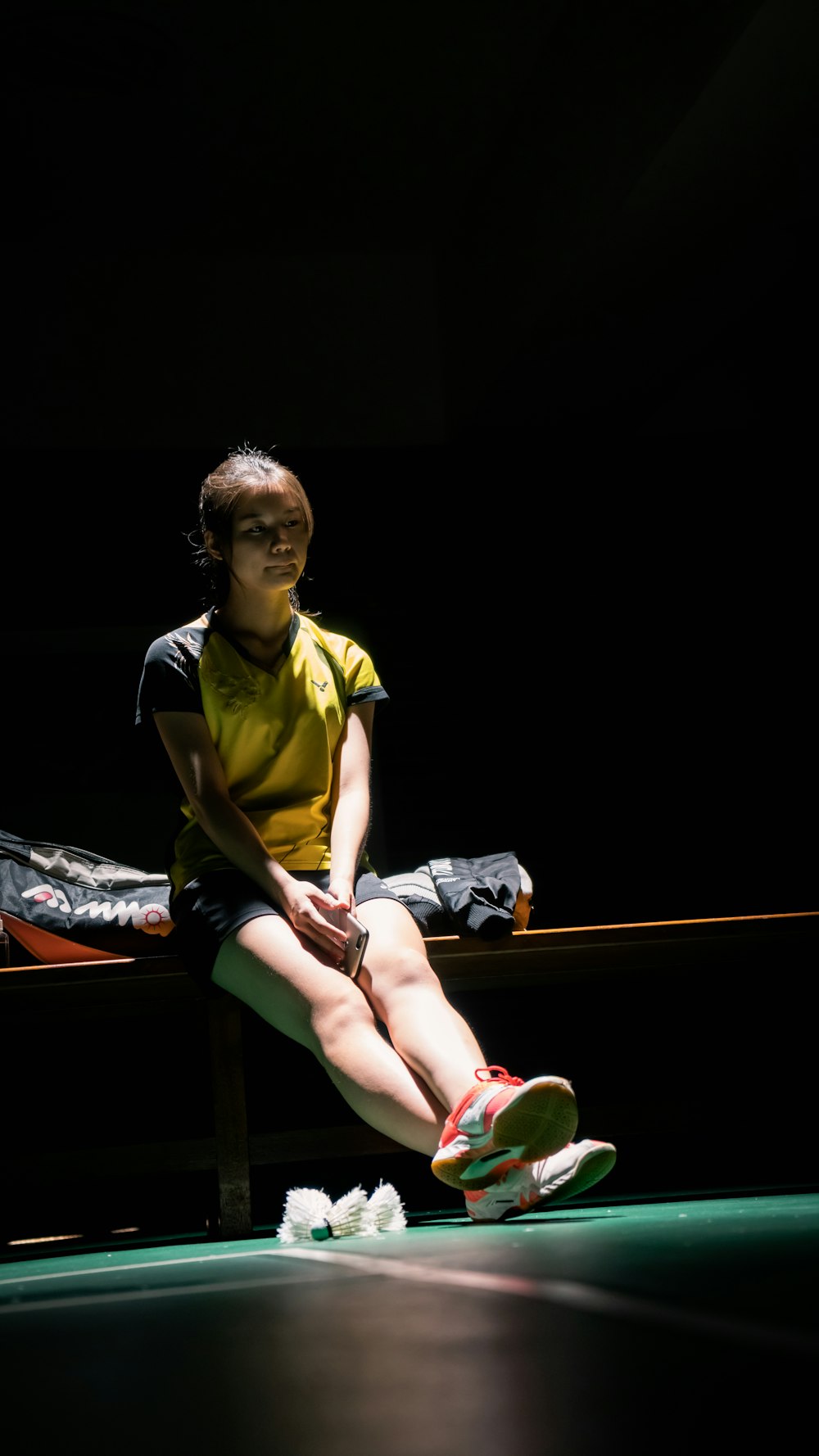 woman sitting on wooden bench