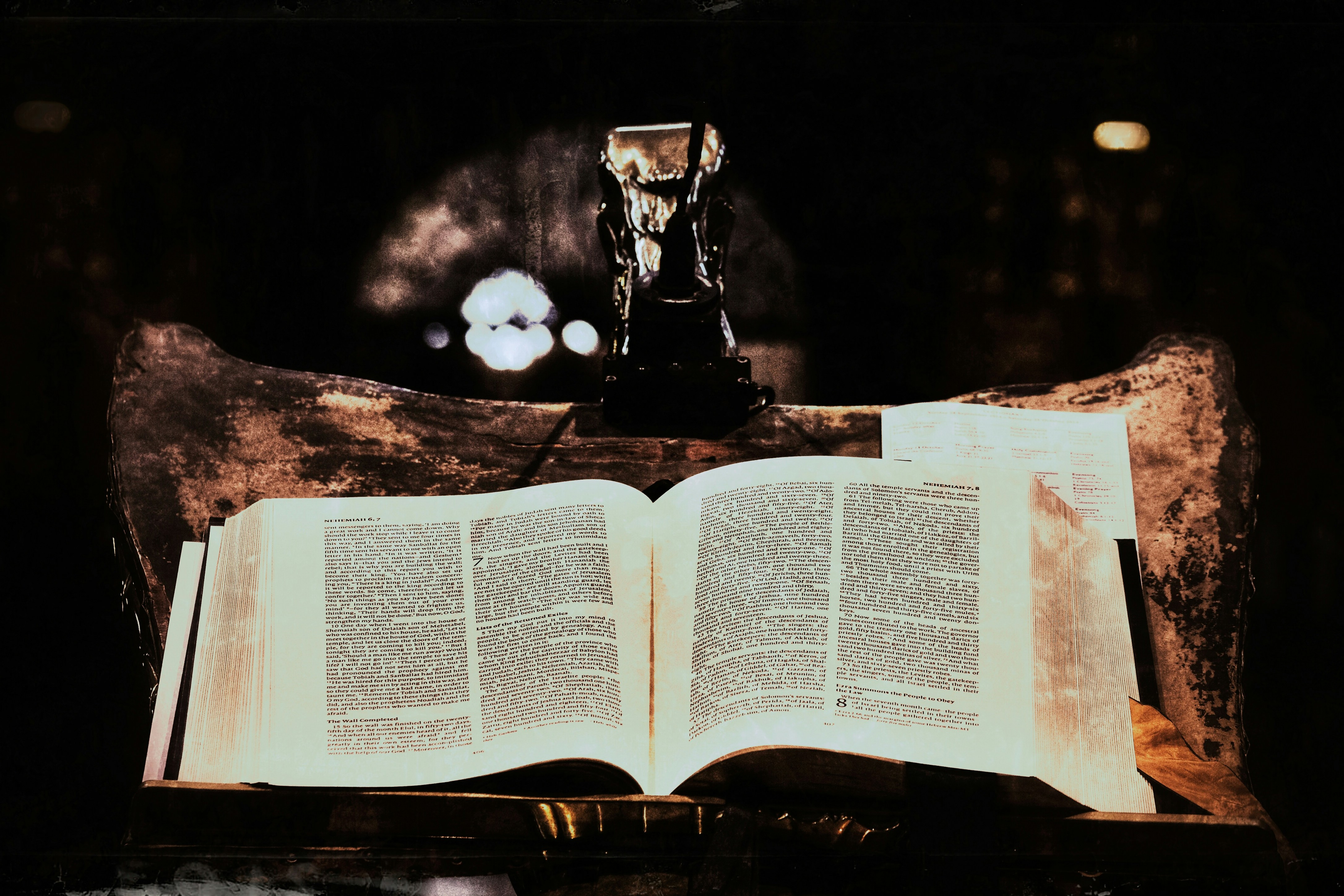 Rare first edition book displayed open on antique wooden stand, soft reading light