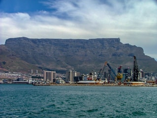 A vibrant two-column layout showing a breathtaking mountain landscape on one side and a lively city street on the other.