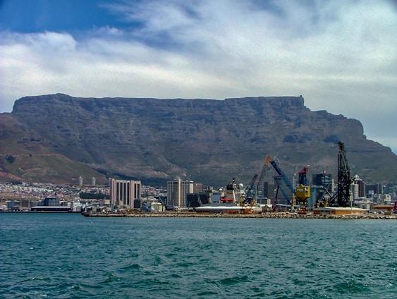 A vibrant two-column layout showing a breathtaking mountain landscape on one side and a lively city street on the other.