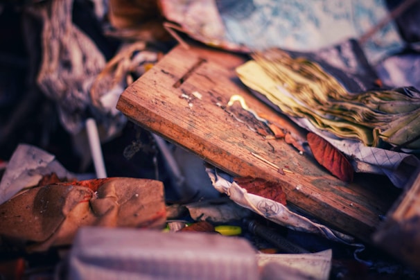 A collection of recycled material items arranged artistically on a wooden table.