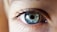 person opening his right eye with blue iris