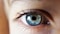 person opening his right eye with blue iris