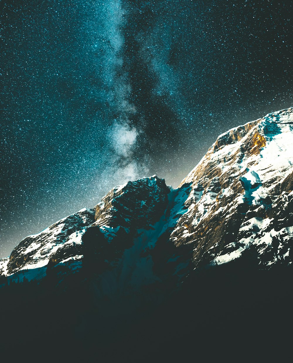 snow covered rocks at nighttime