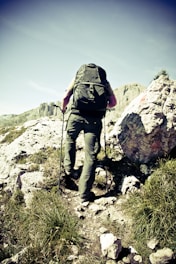man climbing cliff