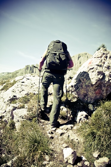 man climbing cliff