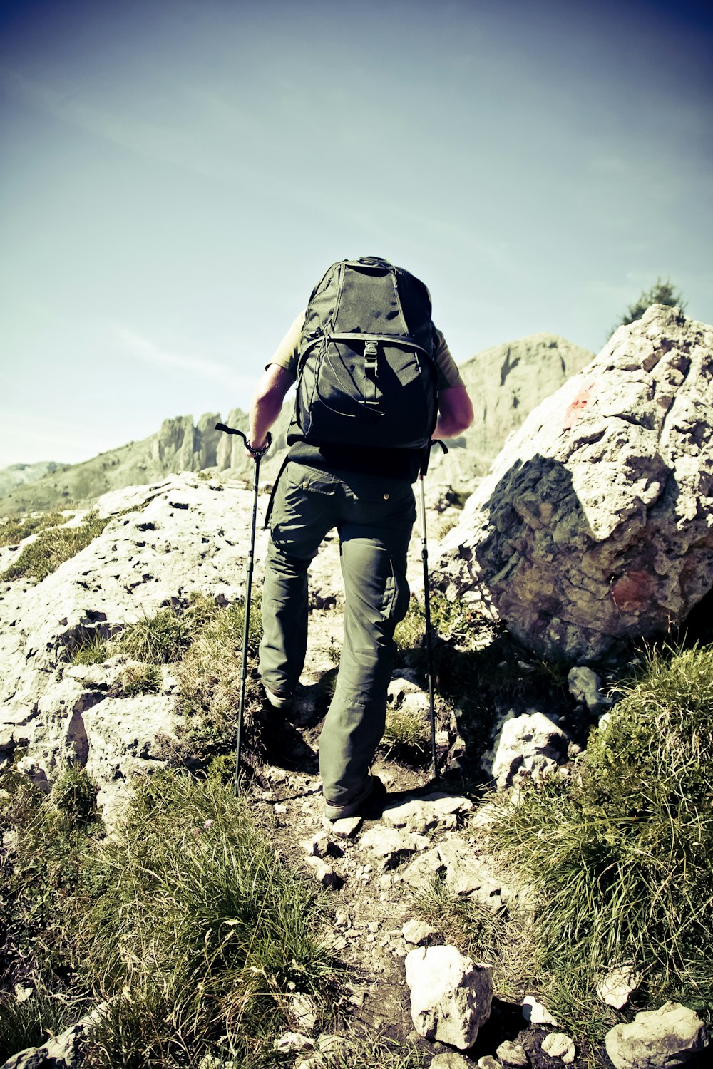 man climbing cliff