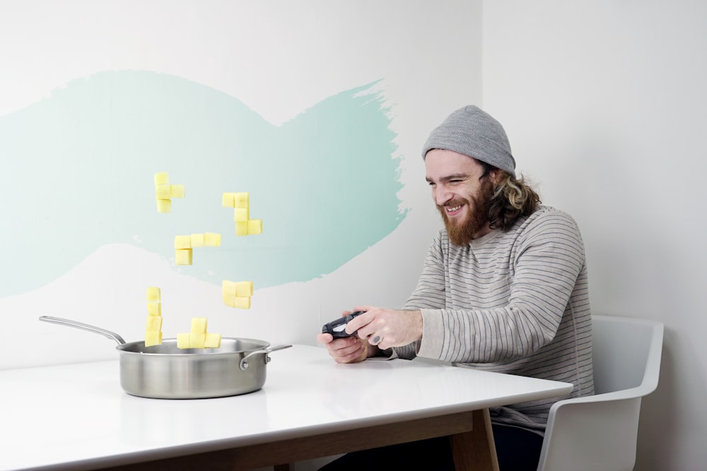 man wearing grey knit cap sitting on the table