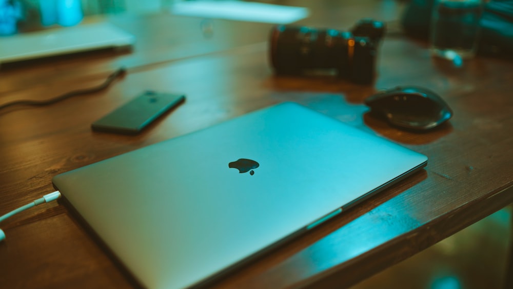 folding silver MacBook on desk