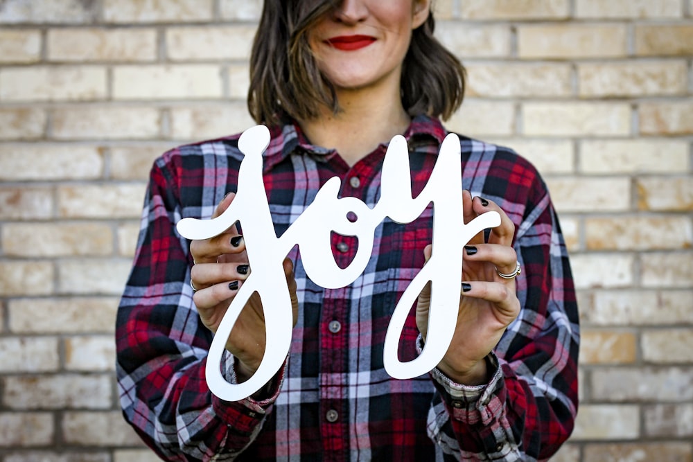 woman holding joy text