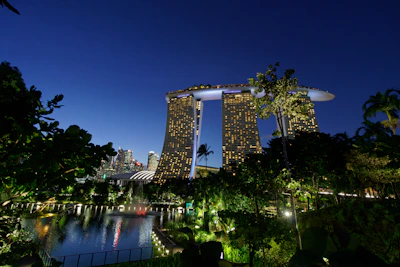 Evening view of the illuminated R&F Seine complex, with lush greenery and peaceful walkways.