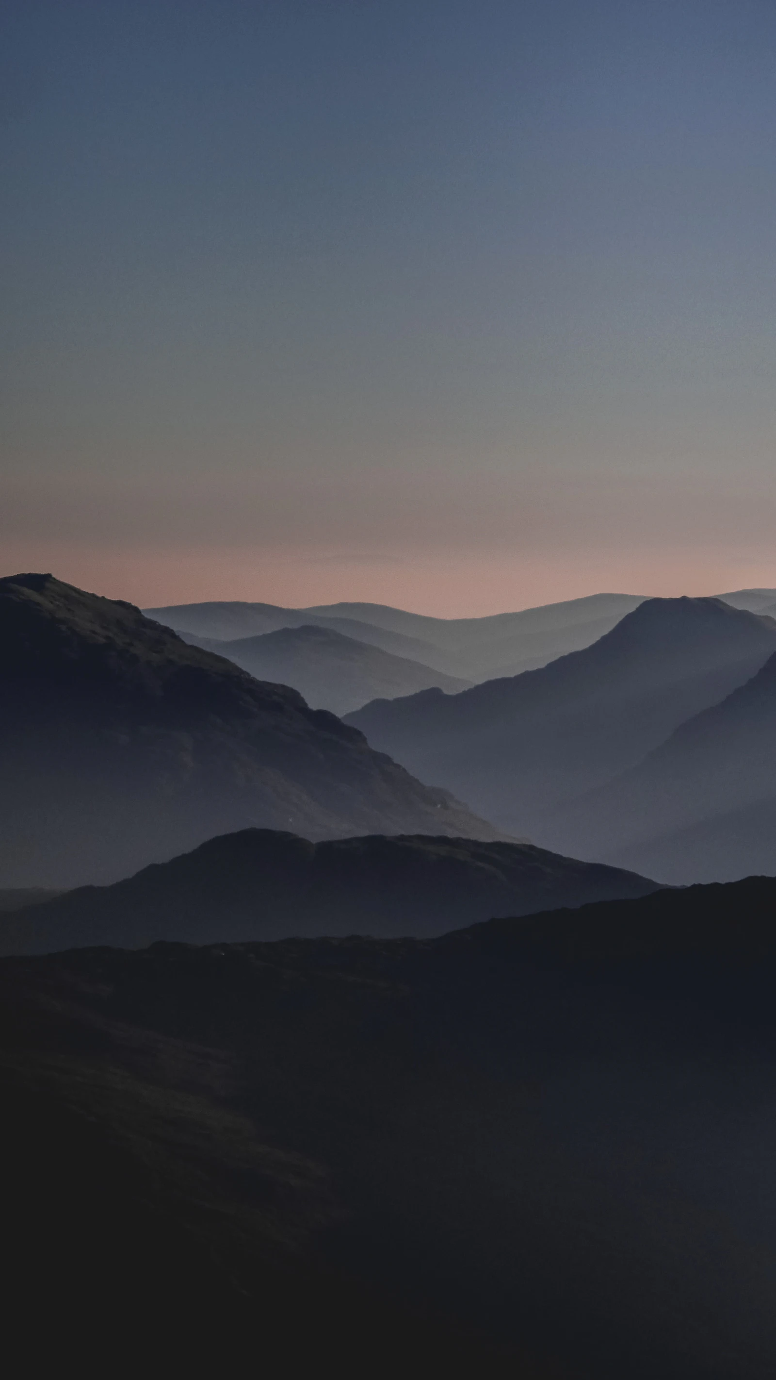 Layered blue ridges fading into haze