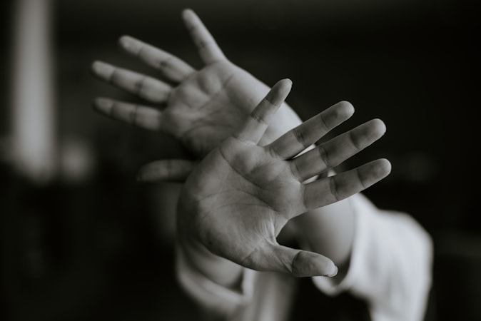 Person stretching their hands and fingers outward for wrist relief and flexibility