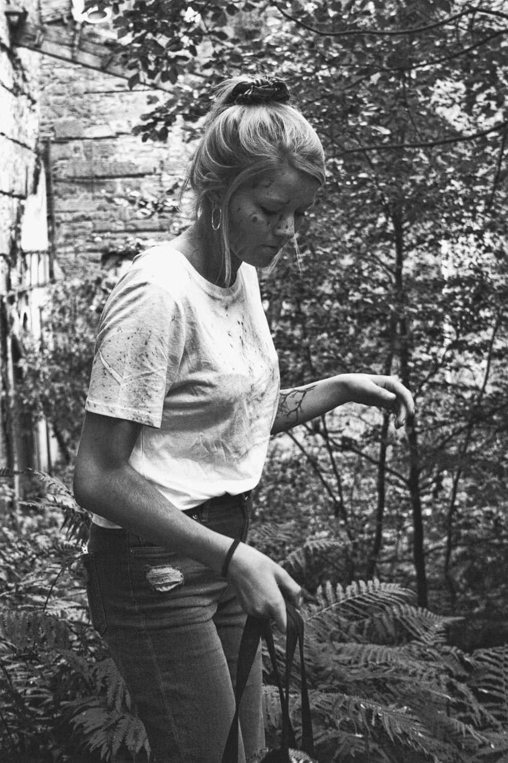 grayscale photo of woman near trees