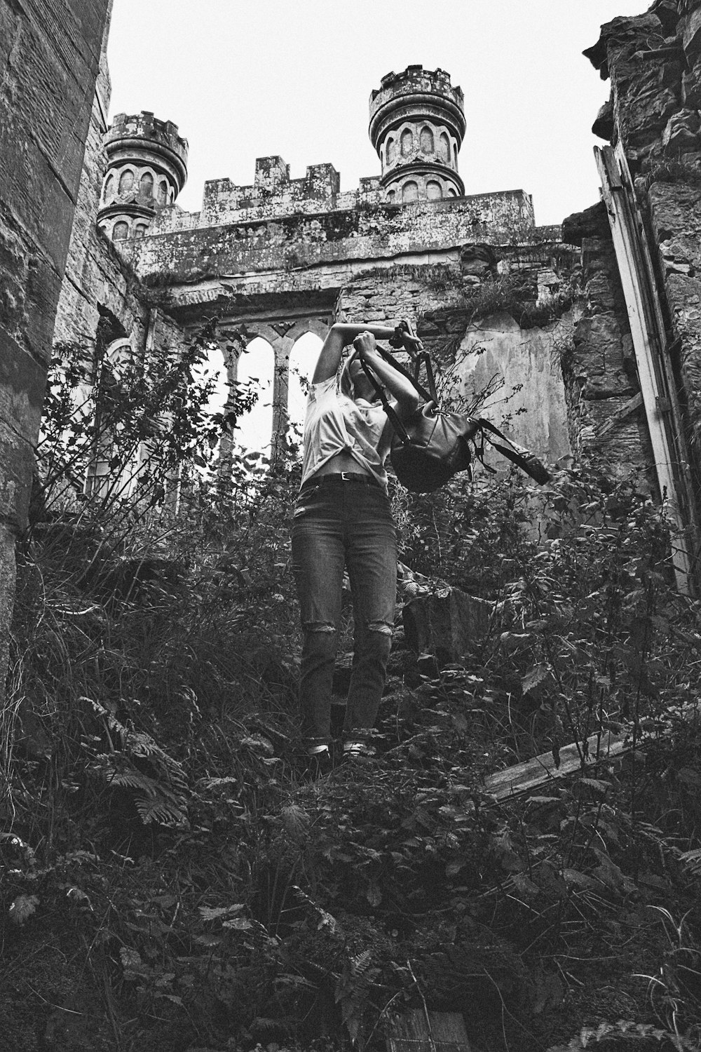 woman holding backpack near ruins