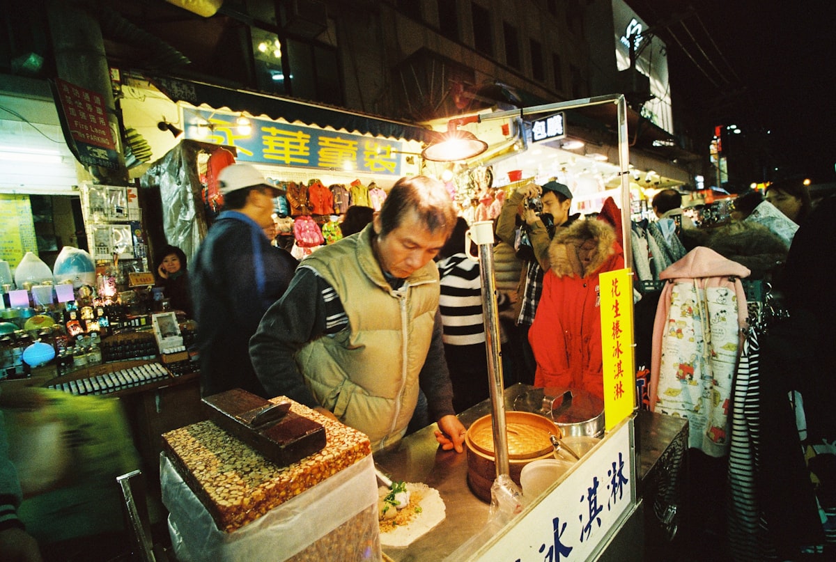 A vendor preparing food at a night market food stall in Taiwan