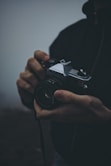 person holding black Fujica camera