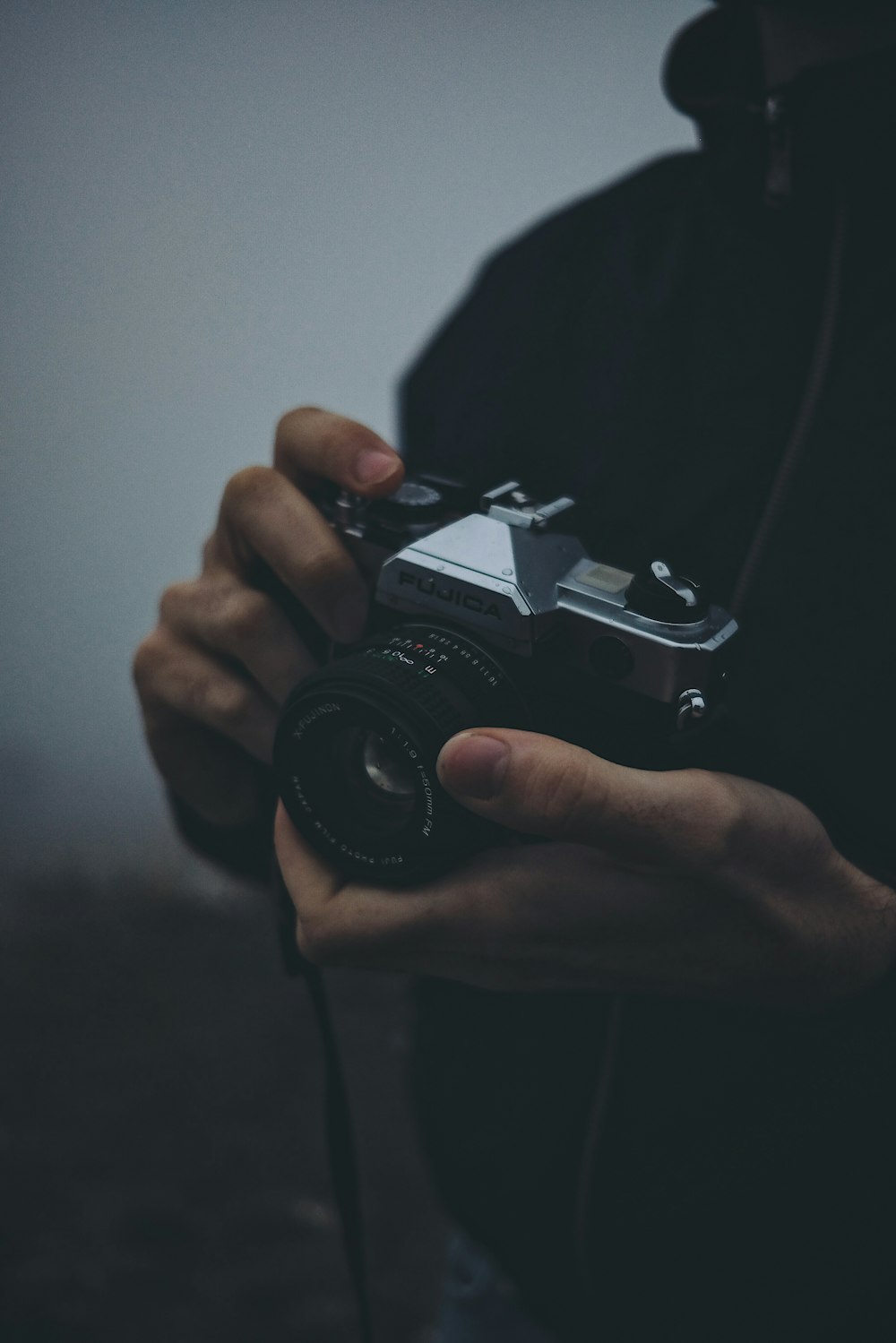 person holding black Fujica camera