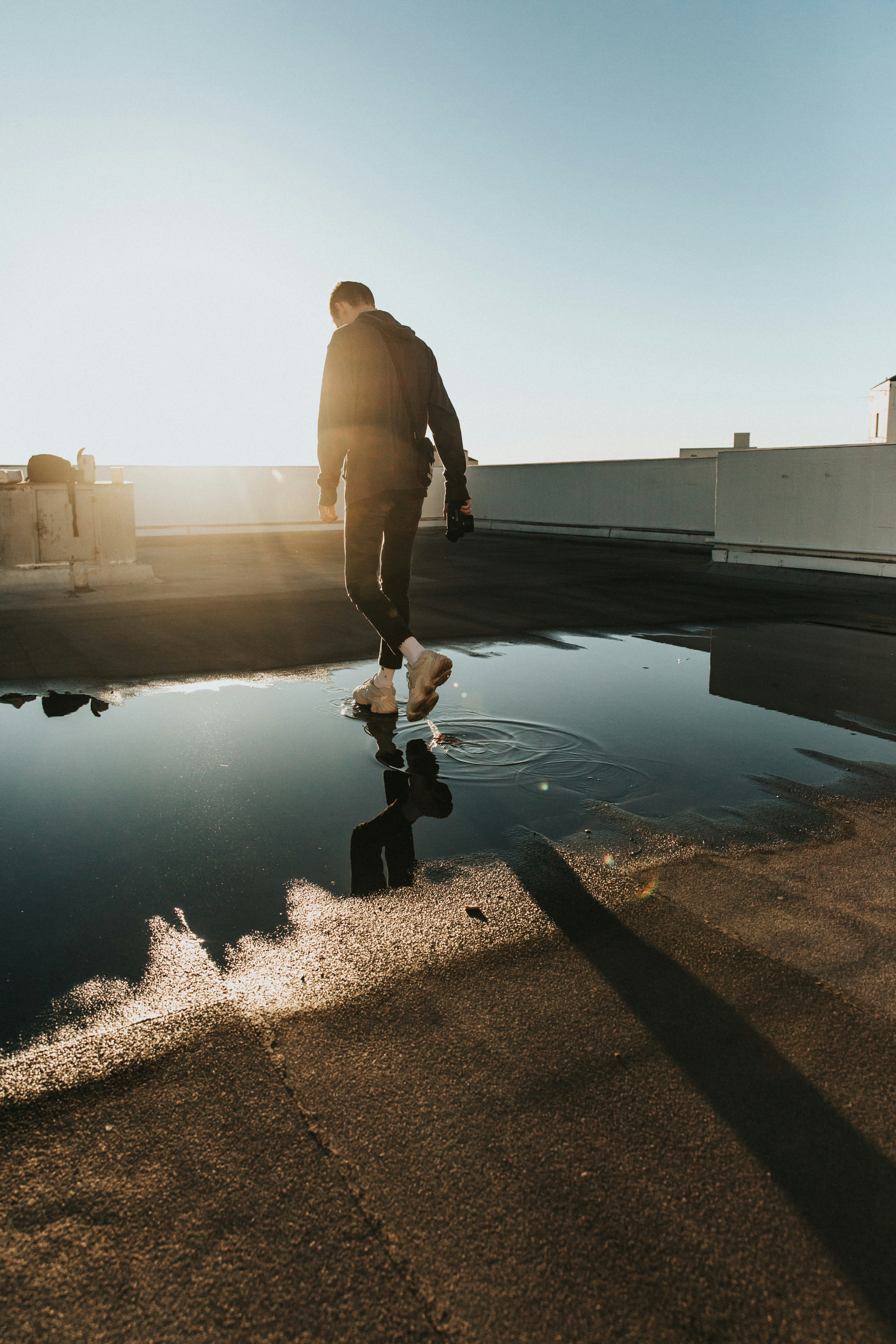 man walking on water puddle